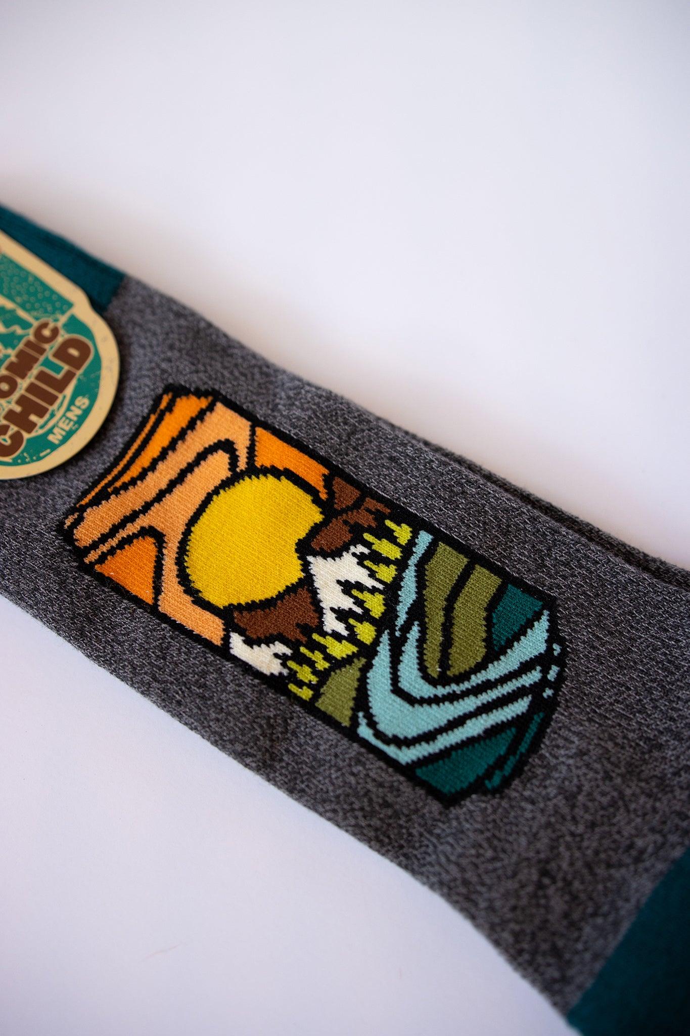 boot socks with beer can shape filled with mountains and trees