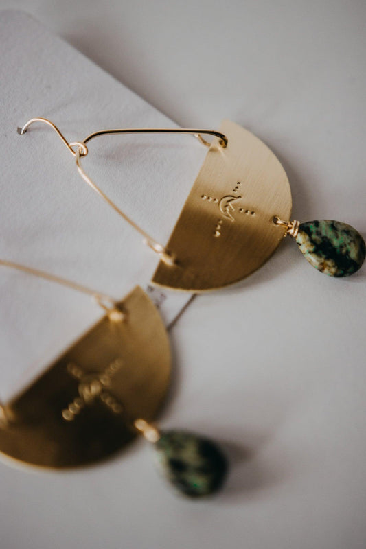 gold dangle earrings with mountain design and turquoise teardrop gem