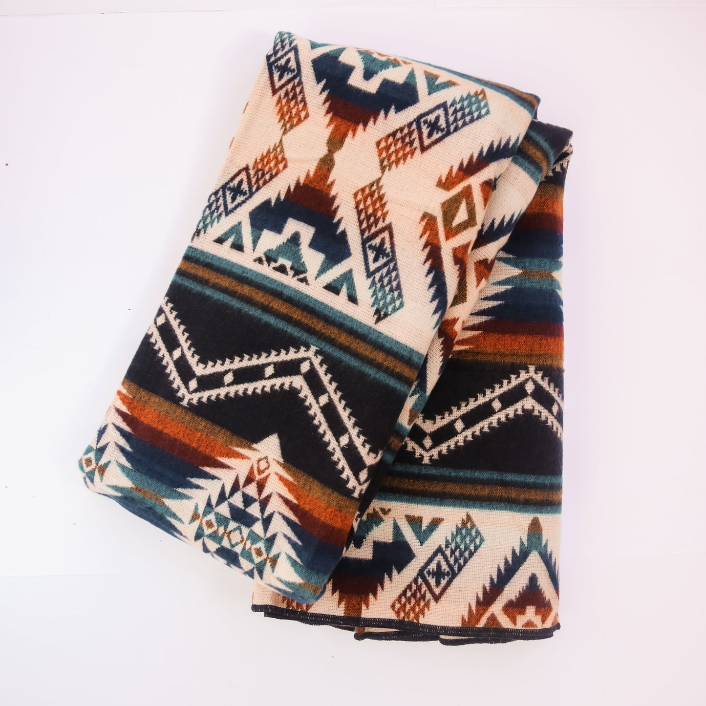 Folded blanket with geometric pattern on a white background