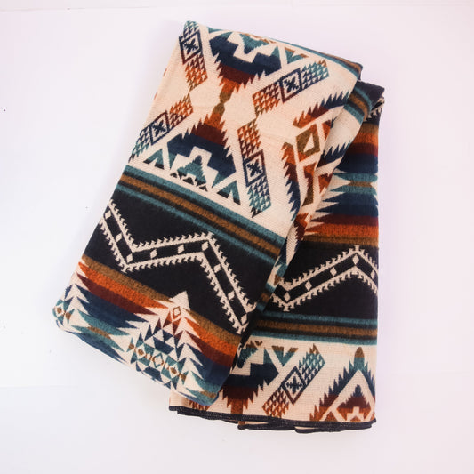 Folded blanket with geometric pattern on a white background