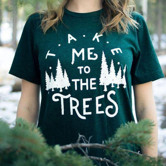 woman wearing olive green take me to the trees shirt.