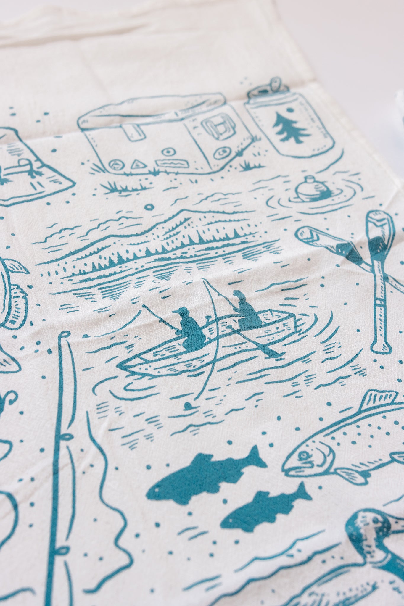 Lake Life printed tea towel with blue lake-themed illustrations