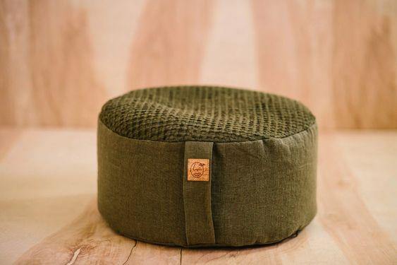 Olive-colored waffle and linen meditation cushion with cork tag
